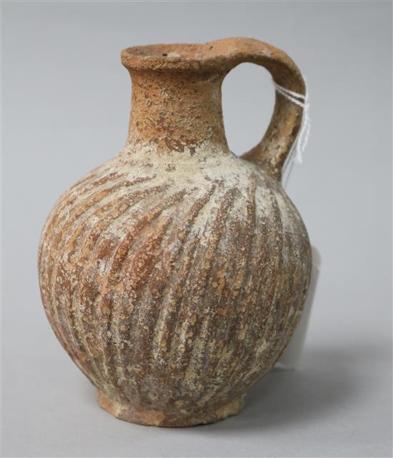 A Roman wrythen fluted terracotta jug